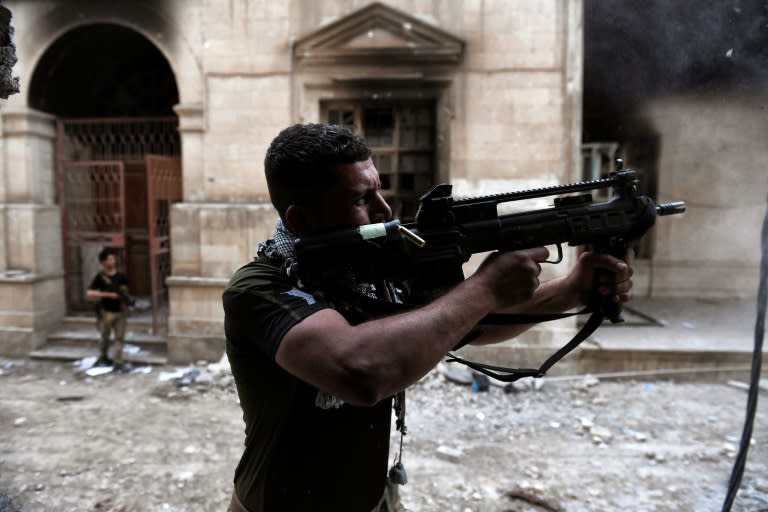 An Iraqi forces member fires towards Islamic State group jihadists in west Mosul on March 11, 2017