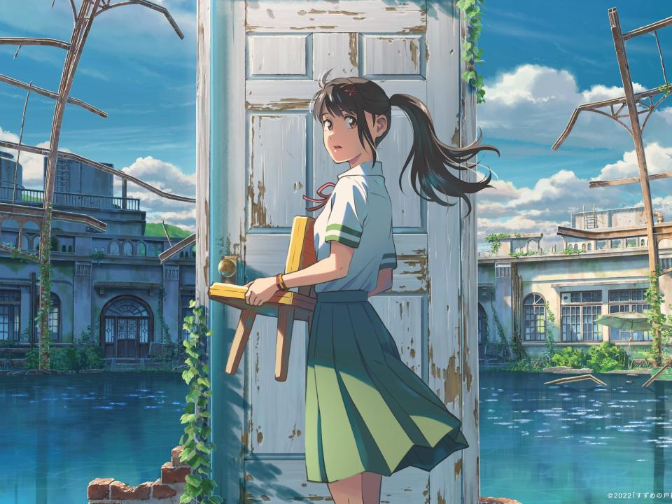 suzume in the anime film suzume — she's a teenage girl with her hair pulled back in a ponytail and with a red clip holding back her bangs, dressed in a school uniform with a green skirt, white shirt, and red ribbon around her neck. she's standing in the center of a shallow pool, the remnants of a bath house, in front of a weathered door. in her hands, she's holding a three-legged children's chair