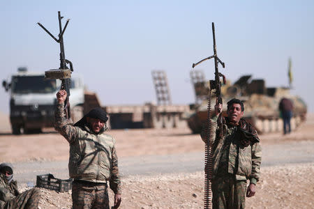 FILE PHOTO: Syrian Democratic Forces (SDF) fighters hold up their weapons in the north of Raqqa city, Syria February 3, 2017. REUTERS/Rodi Said/File Photo