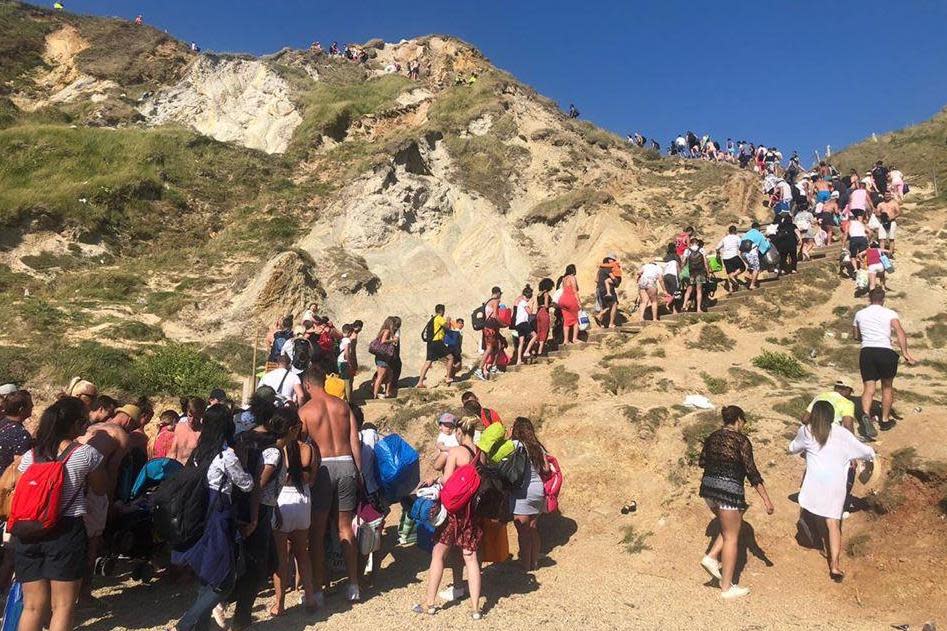 Thousands of sunseekers streamed up narrow coast paths as the beach was evacuated (Purbeck Police)