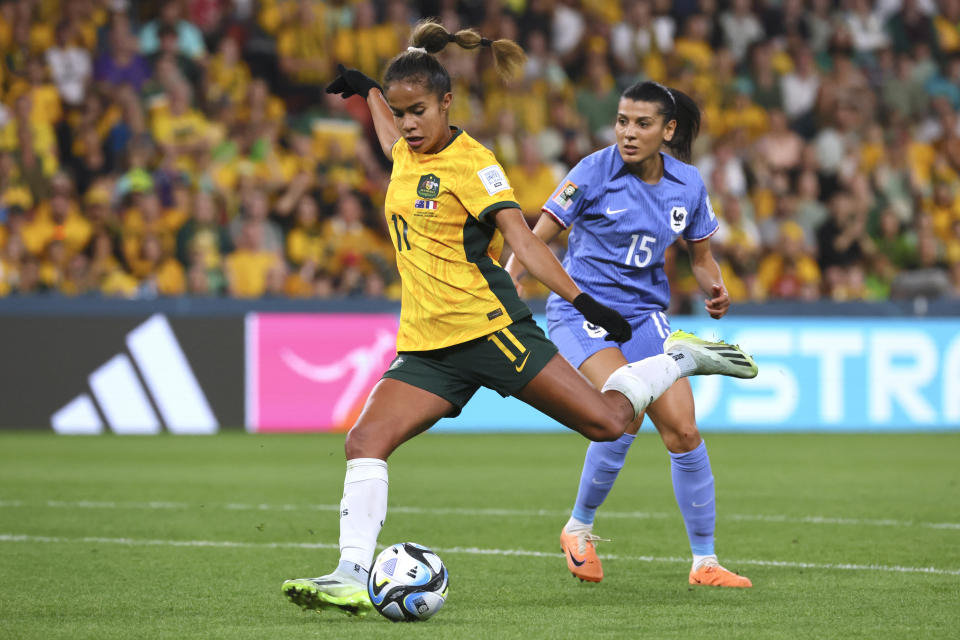 Australia's Mary Fowler kicks the ball ahead of France's Kenza Dali during the Women's World Cup quarterfinal soccer match between Australia and France in Brisbane, Australia, Saturday, Aug. 12, 2023. (AP Photo/Tertius Pickard)