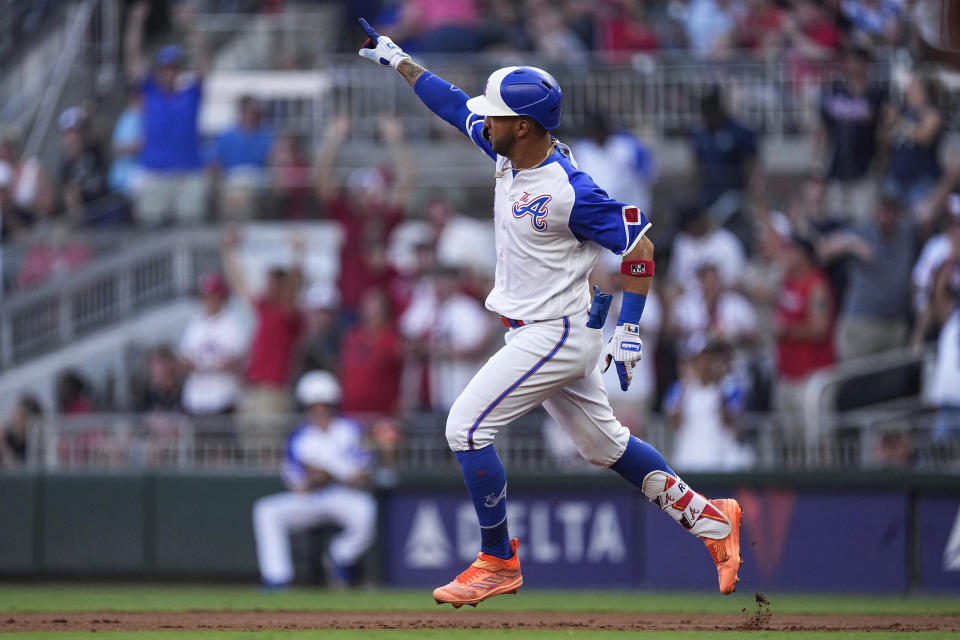Atlanta Braves' Eddie Rosario gestures while running the bases on a two-run home run against the Milwaukee Brewers during the first inning of a baseball game Saturday, July 29, 2023, in Atlanta. (AP Photo/John Bazemore)
