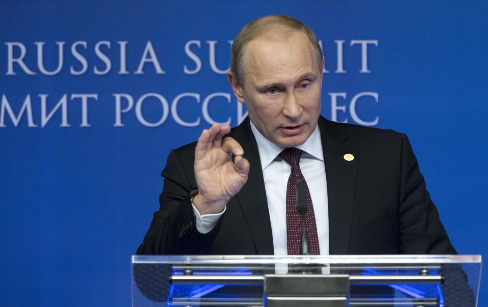 Russian President Vladimir Putin gestures while speaking during a news conference at the European Commission headquarters in Brussels, Belgium, Tuesday, Jan. 28, 2014. Russian President Vladimir Putin and European Union leaders are looking for meager common ground during what promises to be a difficult summit centering on Ukraine and human rights. (AP Photo/Alexander Zemlianichenko)