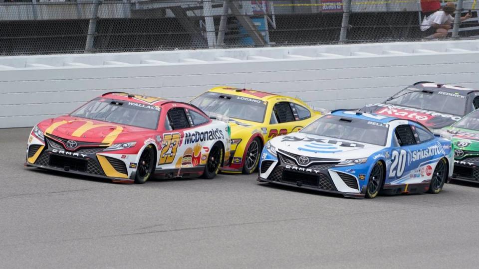 Bubba Wallace (23) races Joey Logano (22) and Christopher Bell (20) in the NASCAR Cup Series auto race at the Michigan International Speedway in Brooklyn, Mich., Sunday, Aug. 7, 2022. (AP Photo/Paul Sancya)