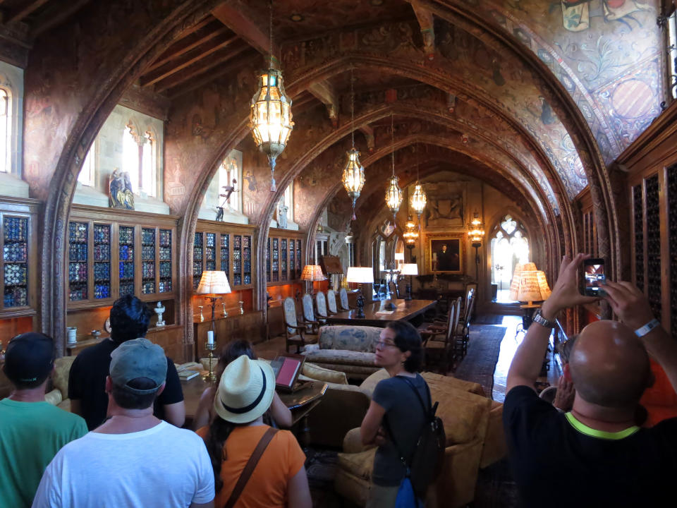 This Aug. 30, 2013 photo shows visitors touring the office at The Hearst Castle, the 165-room estate of newspaper publisher William Randolph Hearst, in San Simeon, Calif. (AP Photo/Jim MacMillan)