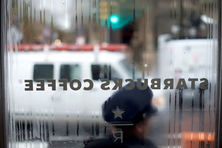 Police officers monitor activity outside as protestors demonstrate inside a Center City Starbucks, where two black men were arrested, in Philadelphia, Pennsylvania U.S., April 16, 2018. REUTERS/Mark Makela