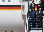 German President Frank-Walter Steinmeier, front right, and Israeli President Isaac Herzog, front left, arrive with their wife's Elke Buedenbender, back left, Michal Herzog, back right, at the Munich airport in Hallbergmoos near Munich, Germany, Monday, Sept. 5, 2002. The German and Israeli presidents are to join relatives of the 11 Israeli athletes killed in the attack by Palestinian militants on the 1972 Munich Olympics at a commemoration event in Munich to mark the 50th anniversary. (Stefan Puchner/dpa via AP)