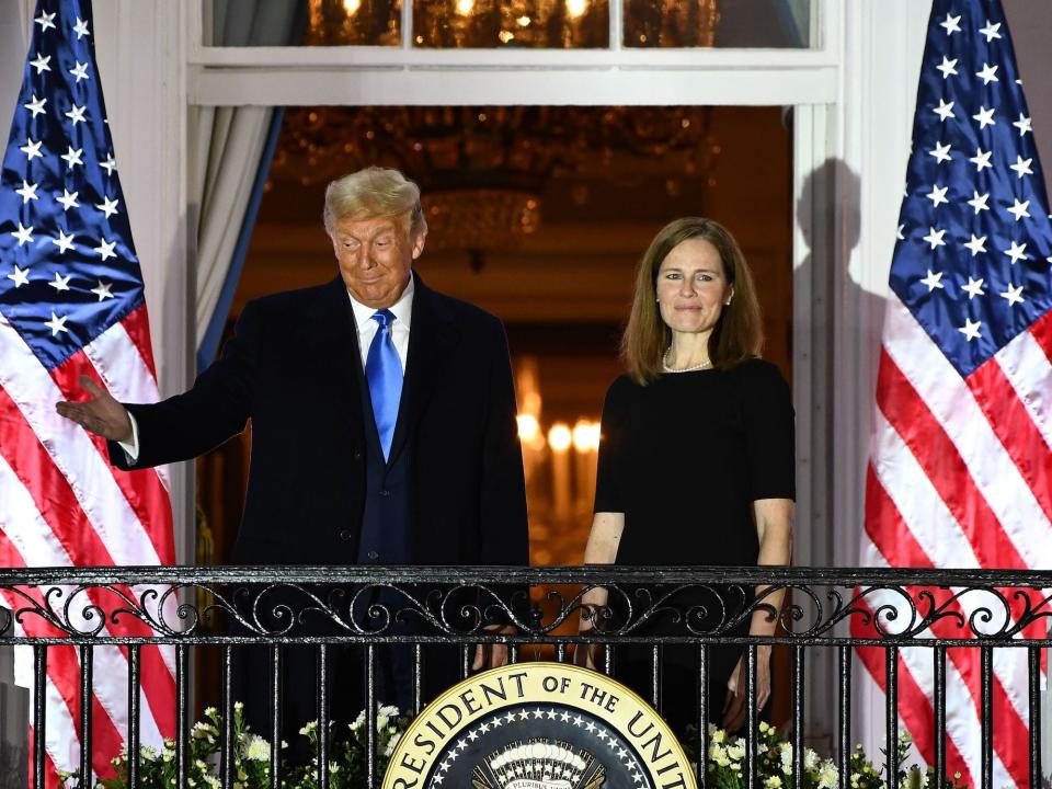 Trump stands with now-Justice Amy Coney Barrett at the White House after she was sworn in on October 26, 2020.