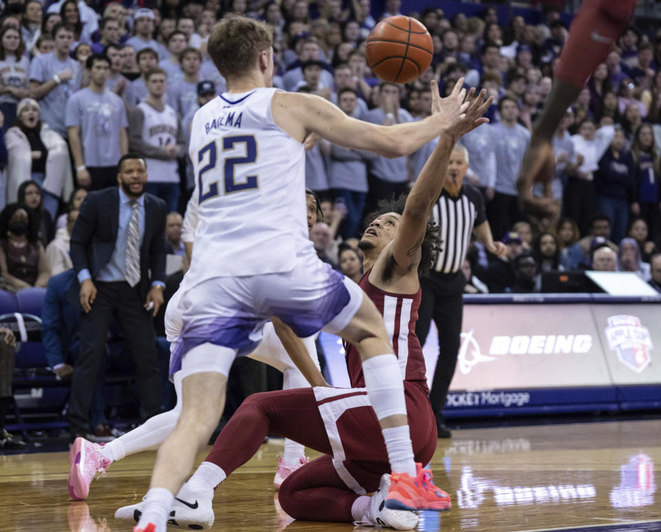 Washington State forward DJ Rodman and Washington guard Cole Bajema (22) try to get possession of the ball during the first half of an NCAA college basketball game Thursday, March 2, 2023, in Seattle. (AP Photo/Stephen Brashear)