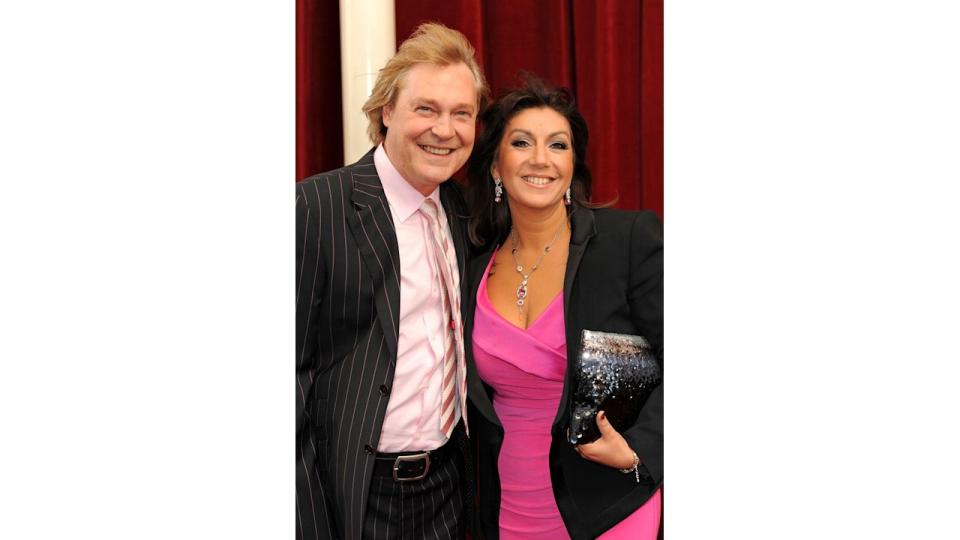 Ed Rothe standing with Jane McDonald