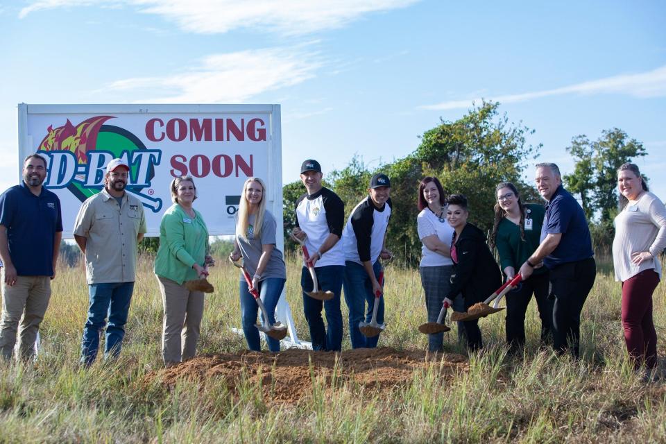 Kevin and Alan Dickinson pose with members of the Fort Smith Chamber of Commerce for the groundbreaking of their new baseball and softball training facility in early October.