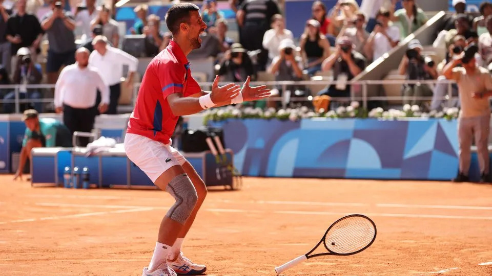 Djokovic celebrates winning match point against Alcaraz. - Clive Brunskill/Getty Images