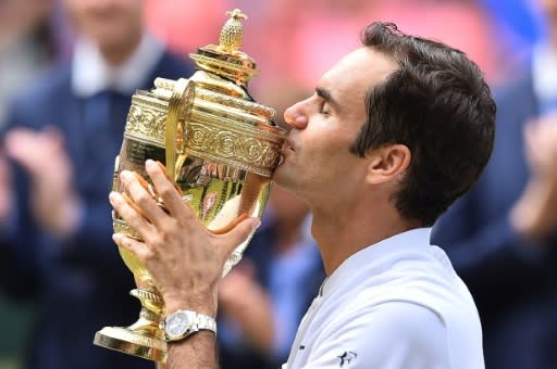 Eighth time around: Roger Federer kisses the winner's trophy after beating Marin Cilic in the 2017 Wimbledon final