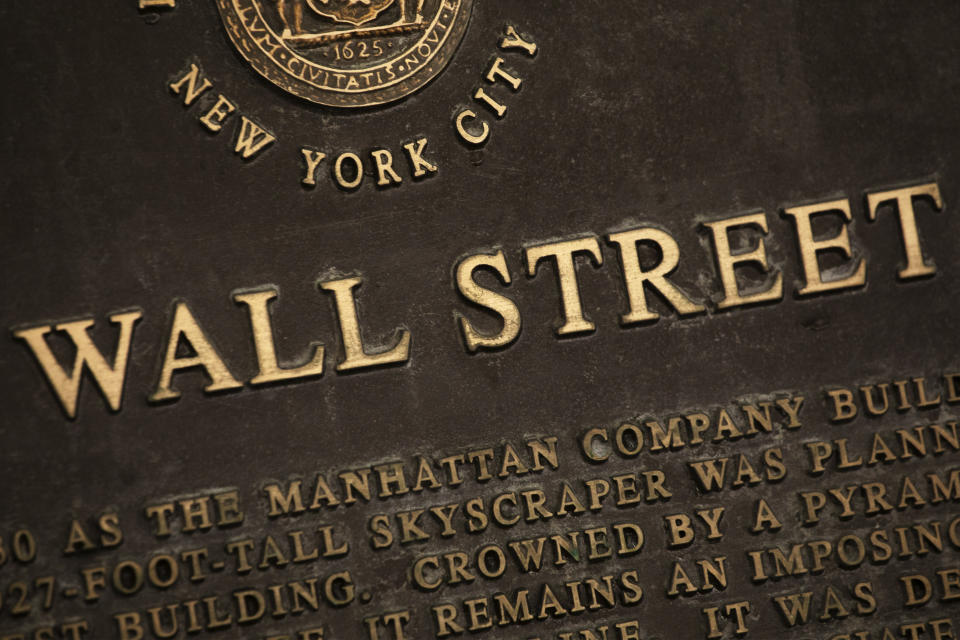 FILE - In this May 26, 2020 file photo, a historic marker for Wall Street is shown in New York's financial district. Stocks are off to a mixed start on Wall Street Tuesday, Sept. 29 as the market cooled off following a rally the day before and as investors waited for the presidential debate between former Vice President Joe Biden and President Donald Trump. Banks and industrial companies had some of the biggest losses shortly after the opening bell Tuesday, while several big technology and communications companies were higher. (AP Photo/Mark Lennihan, File)