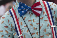 <p>Lilly Kleinschmidt, 12, of Muncie, Indiana, wears a patriotic hot dog themed outfit to watch her mother Holly Titus compete in the Nathan’s Famous Fourth of July hot dog eating contest, Wednesday, July 4, 2018, in New York’s Coney Island. (Photo: Mary Altaffer/AP) </p>