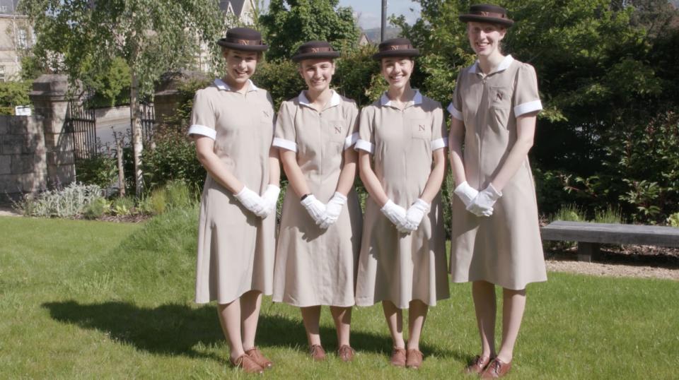 image of 4 uniformed Norland nannies smiling in a park