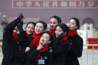 Hospitality staff take selfies on Tiananmen Square during the opening session of the Chinese People's Political Consultative Conference (CPPCC) held at the Great Hall of the People in Beijing, Sunday, March 3, 2019. Thousands of delegates from around China have gathered in Beijing for the annual session of the country's rubber-stamp legislature and its advisory body. (AP Photo/Andy Wong)