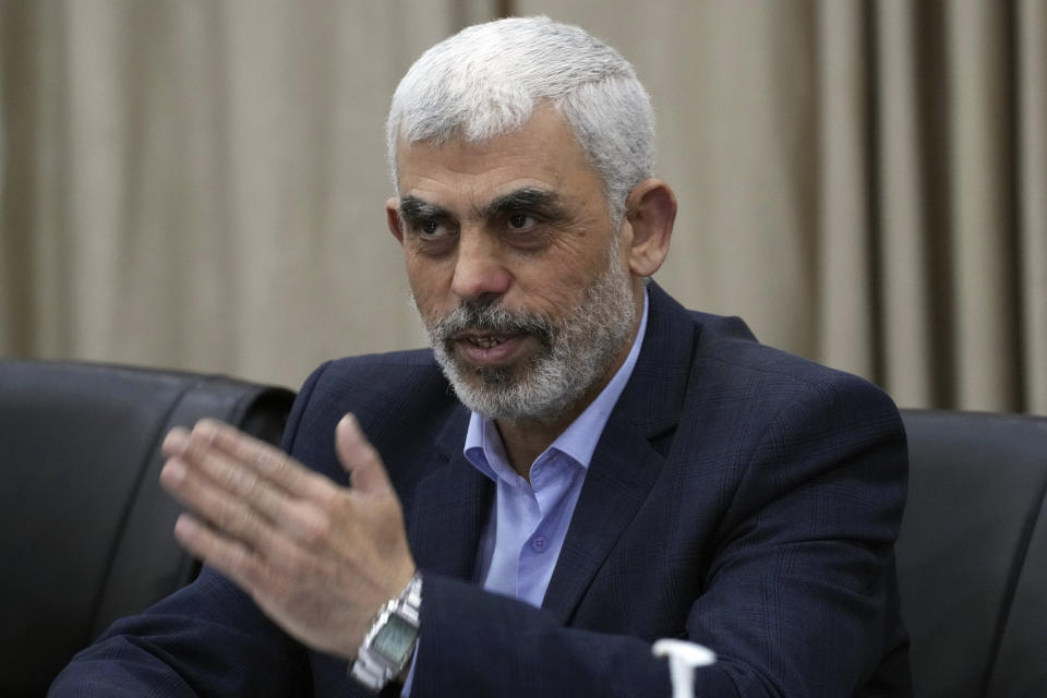 FILE - Yahya Sinwar, head of Hamas in Gaza, greets his supporters during a meeting with leaders of Palestinian factions at his office in Gaza City, April 13, 2022. Days of violence in Jerusalem and an exchange of fire in Gaza overnight have raised the possibility that Israel and Gaza's Hamas rulers will once again go to war, as they did less than a year ago under similar circumstances. For Hamas, another war would devastate Gaza, which has hardly begun to rebuild after the last one. (AP Photo/Adel Hana, File)