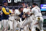 Milwaukee Brewers' Hunter Renfroe is congratulated after hitting a walk-off single during the 10th inning of a baseball game against the Arizona Diamondbacks Monday, Oct. 3, 2022, in Milwaukee. The Brewers won 6-5. (AP Photo/Morry Gash)