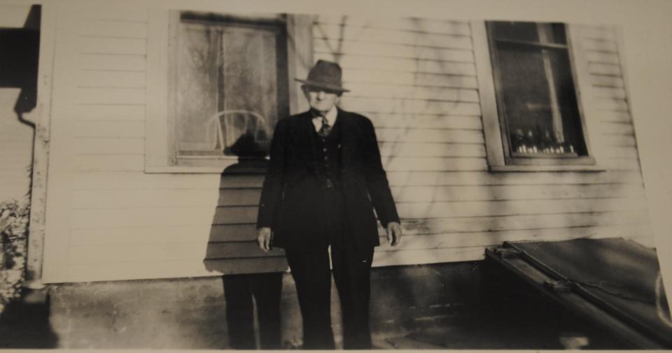 Berry Brown, "Papa" to Marcia McCoy, is seen near the back of the house at 1400 Travis in this undated photo