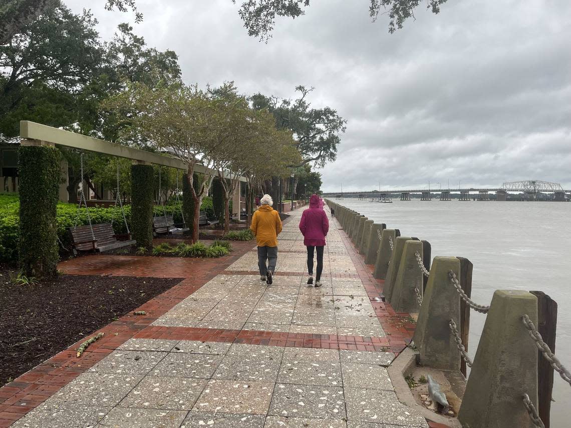 People walk along the waterfront in Beaufort in the wake of Hurricane Ian on Friday, Sept. 30, 2022.