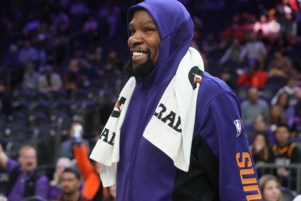 Phoenix Suns forward Kevin Durant (35) smiles from the sidelines during their 116-110 win over the Detroit Pistons at Footprint Center in Phoenix on Feb. 14, 2024.