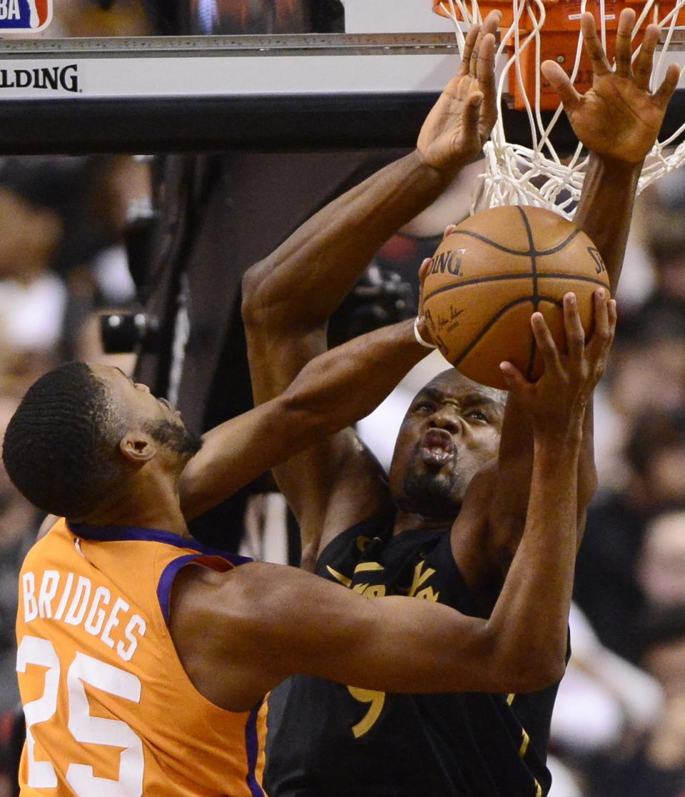 Toronto Raptors center Serge Ibaka (9) defends against Phoenix Suns forward Mikal Bridges (25) during the second half of an NBA basketball game Friday, Feb. 21, 2020, in Toronto. (Frank Gunn/The Canadian Press via AP)