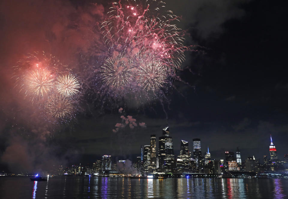 A surprise display of fireworks sponsored by Macy's explode over the Hudson Yards area of Manhattan as seen from a pier in Hoboken, N.J., late Tuesday, June 30, 2020. The fireworks were not announced until an hour or so before to avoid attracting large crowds. (AP Photo/Kathy Willens)