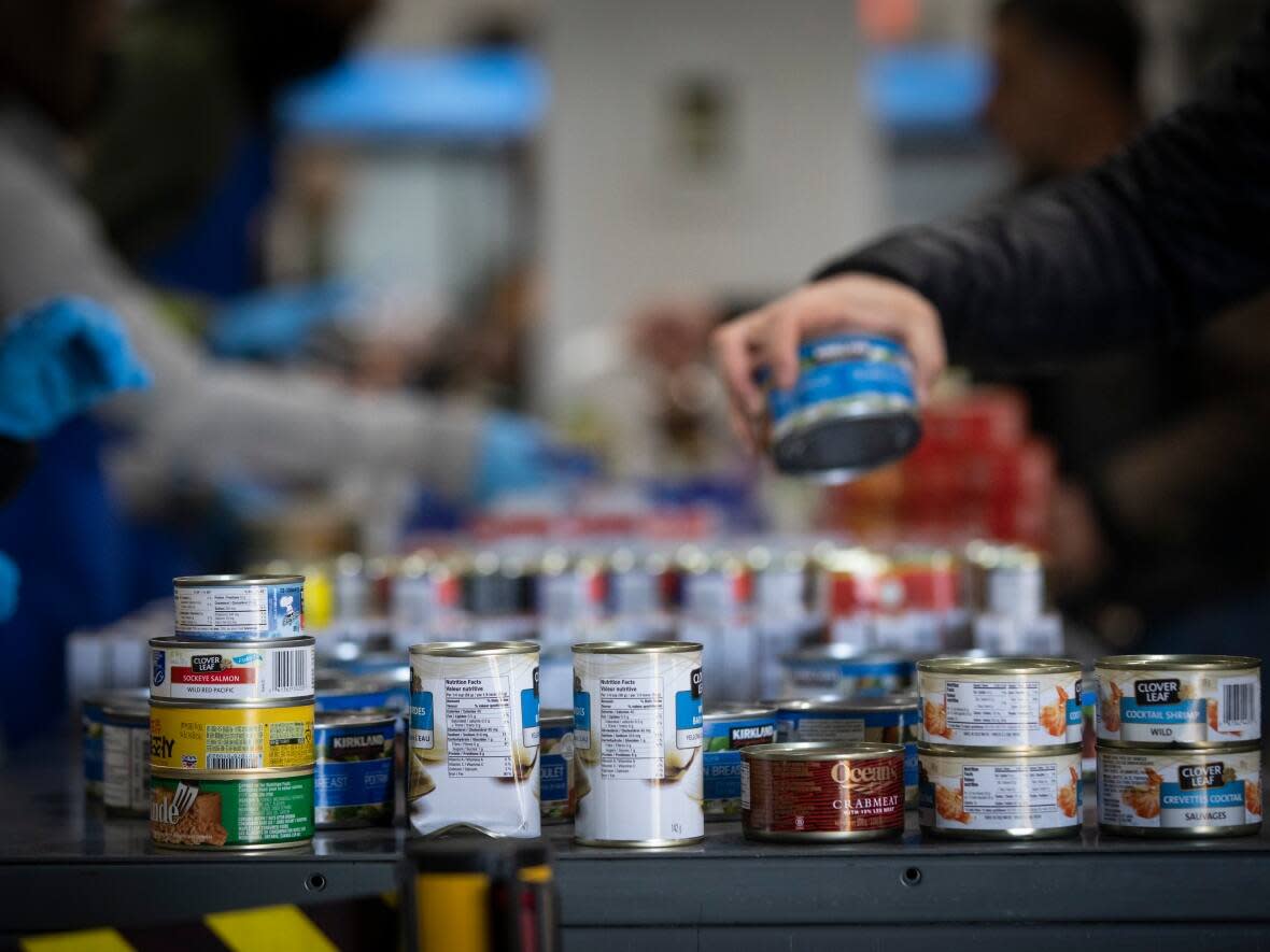 People are pictured at the Surrey Food Bank in Surrey, B.C., on Nov. 24. A report has found that demand for food banks in B.C. increased by 25 per cent between 2021 and 2022, compared to the national average of 15 per cent. (Ben Nelms/CBC - image credit)