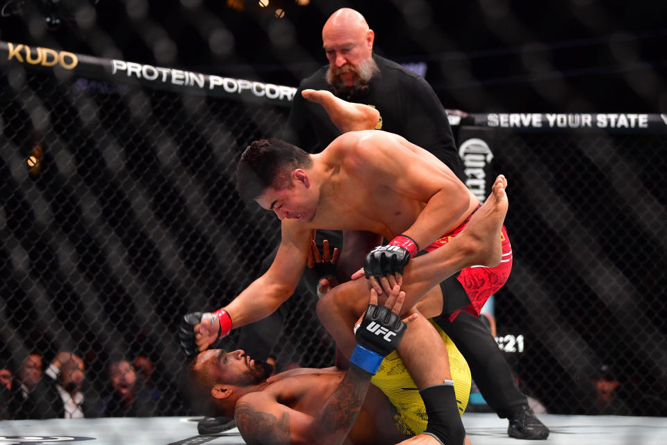 Feb 17, 2024; Anaheim, California, USA; Zhang Mingyang lands a hit against Brendson Ribeiro during UFC 298 at Honda Center. Mandatory Credit: Gary A. Vasquez-USA TODAY Sports