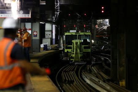 Amtrak track workers work inside the tunnel at New York's Pennsylvania Station which began track repairs causing massive disruptions to commuters in New York City, U.S., July 10, 2017. REUTERS/Brendan McDermid