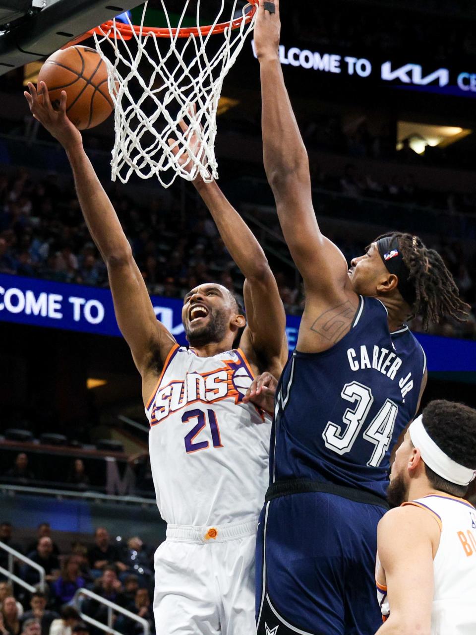 Phoenix Suns forward Keita Bates-Diop (21) drives to the basket past Orlando Magic center Wendell Carter Jr. (34) in the second quarter at the Kia Center in Orlando on Jan. 28, 2024.