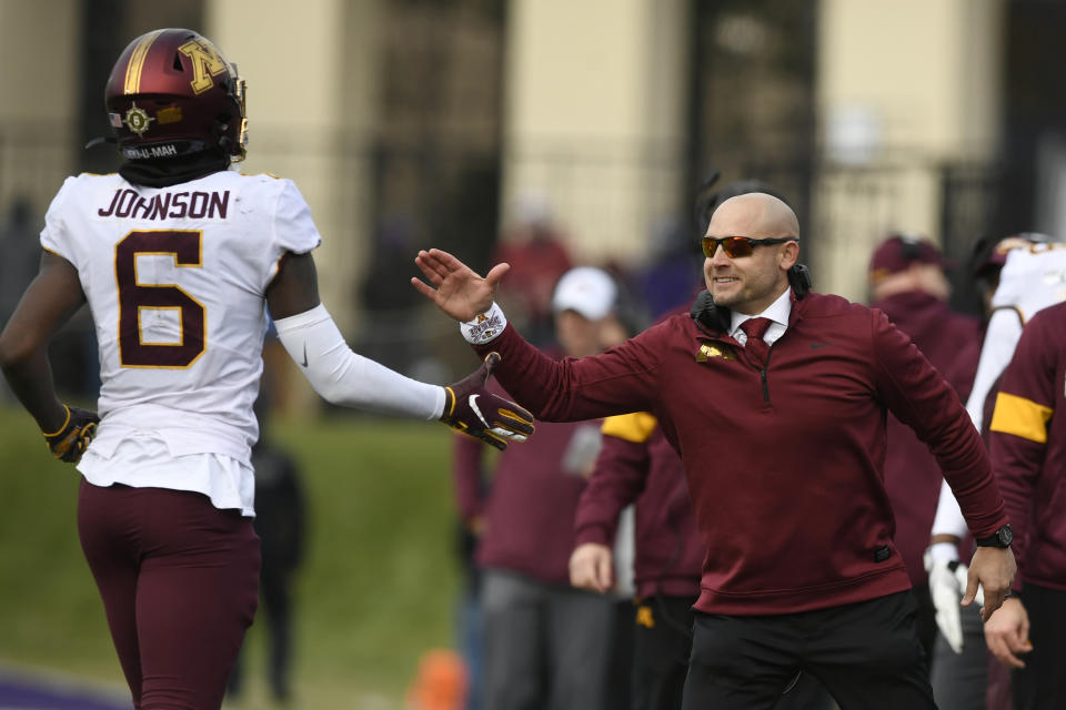 FILE - In this Saturday, Nov. 23, 2019, file photo, Minnesota head coach P.J. Fleck, right, celebrates with wide receiver Tyler Johnson (6) after Johnson caught a touchdown pass during the second half of an NCAA football game against Northwestern, in Evanston, Ill. Fleck has never lacked for clever ways to connect and motivate his players. (AP Photo/Paul Beaty, File)