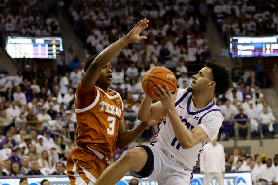 Texas guard Max Abmas (3) defends against TCU guard Trevian Tennyson (11) during the first half of an NCAA college basketball game in Fort Worth, Texas, Saturday, Feb. 3, 2024. (AP Photo/Michael Ainsworth)