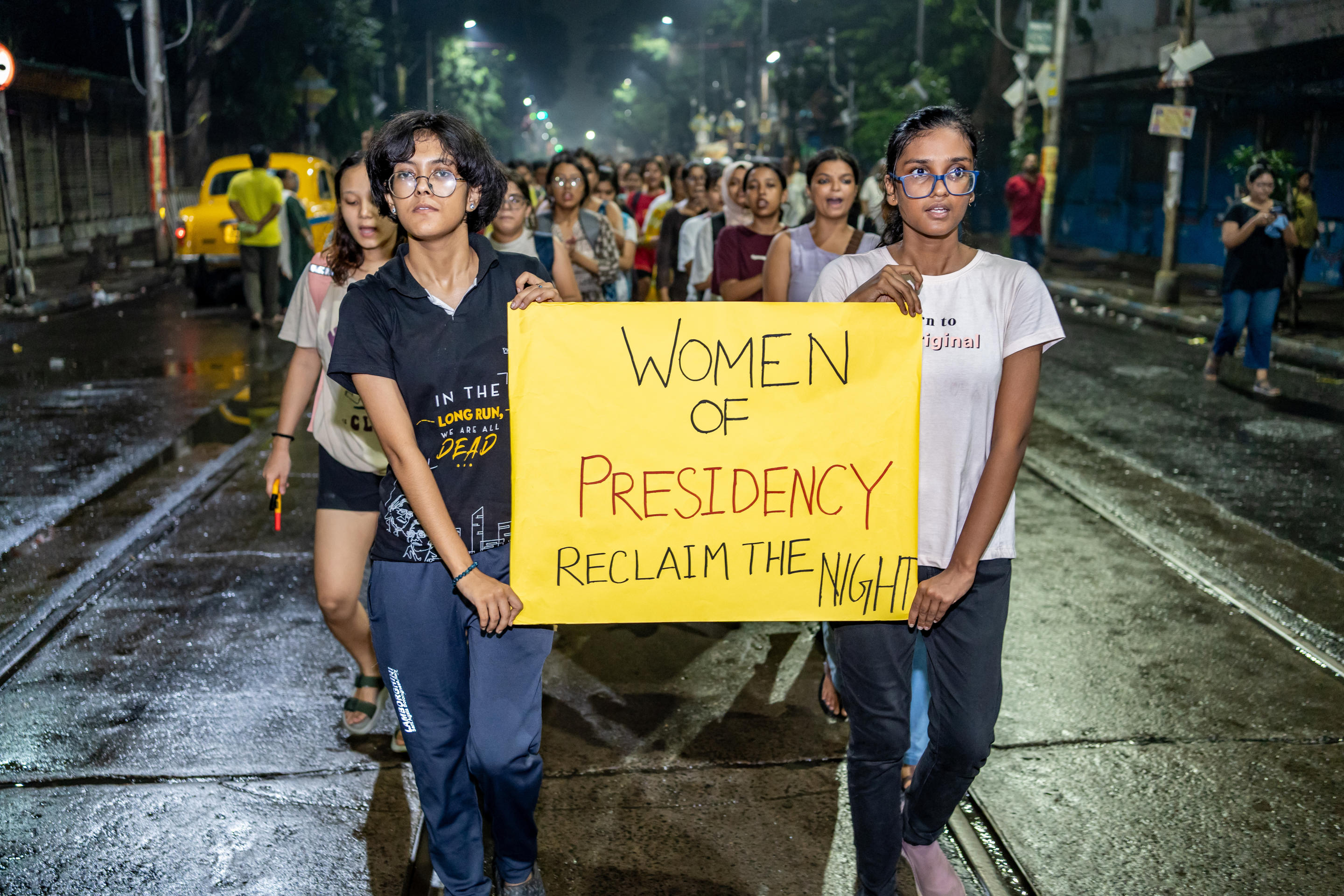 Women hold a banner as they take part in the protest.