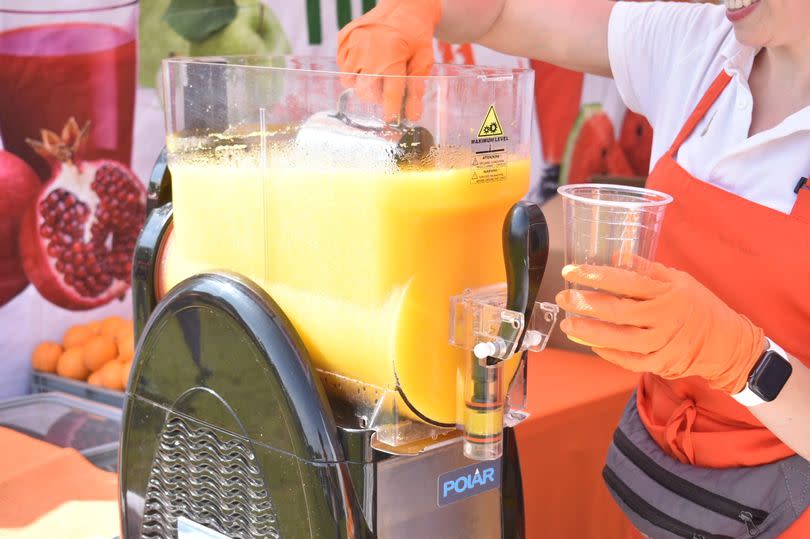 Orange slush being scooped out of a container