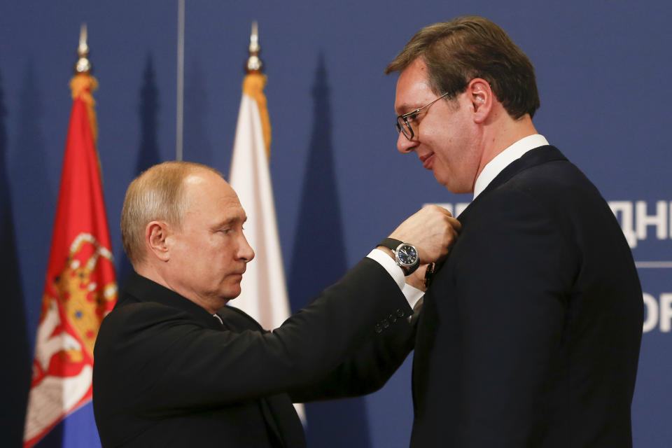 Russian President Vladimir Putin, left, awards Serbian President Aleksandar Vucic with Russia's Order of Alexander Nevsky after their talks in Belgrade, Serbia, Thursday, Jan. 17, 2019. Putin arrives in Serbia on Thursday for his fourth visit to the Balkan country since 2001. (AP Photo/Darko Vojinovic)