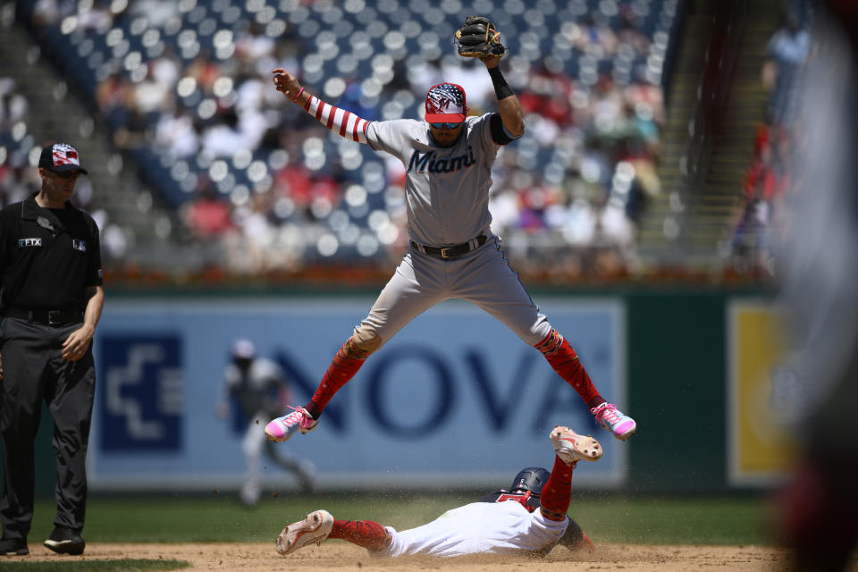 Washington Nationals' Ehire Adrianza, bottom, steals second against Miami Marlins shortstop Miguel Rojas, top, during the eighth inning of a baseball game, Monday, July 4, 2022, in Washington. The Marlins won 3-2 in ten innings. (AP Photo/Nick Wass)