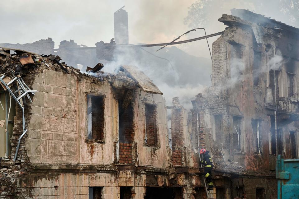 A firefighter examines the destroyed building of a medical facility, the site of a missile strike, in the city of Dnipro on 26 May 2023, amid the Russian invasion of Ukraine (AFP via Getty Images)