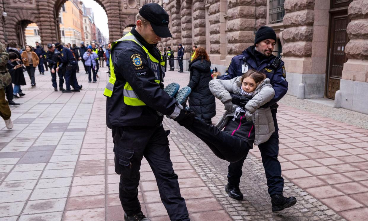 <span>Greta Thunberg is arrested by police officers during a climate protest outside the Swedish parliament in Stockholm, Sweden, in March.</span><span>Photograph: Michael Campanella/Getty Images</span>