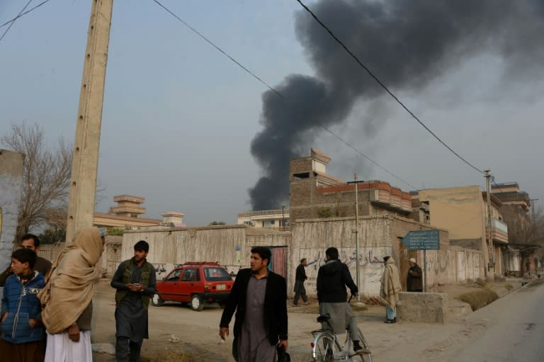 A plume of smoke rises from the compound of the British charity Save the Children during an attack in Jalalabad