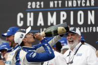 NTT IndyCar series champion Alex Palou celebrates after taking the title during an auto race at Grand Prix of Long Beach, Sunday, Sept. 26, 2021, in Long Beach, Calif. (AP Photo/Alex Gallardo)