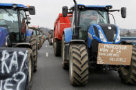 French farmers drive their tractors on the A7 highway to protest changes in underprivileged farm area’s mapping and against Mercosur talks, in Pierre-Benite near Lyon, France, February 21, 2018. Message reads "Mercosur, no to unfair competition". REUTERS/Emmanuel Foudrot