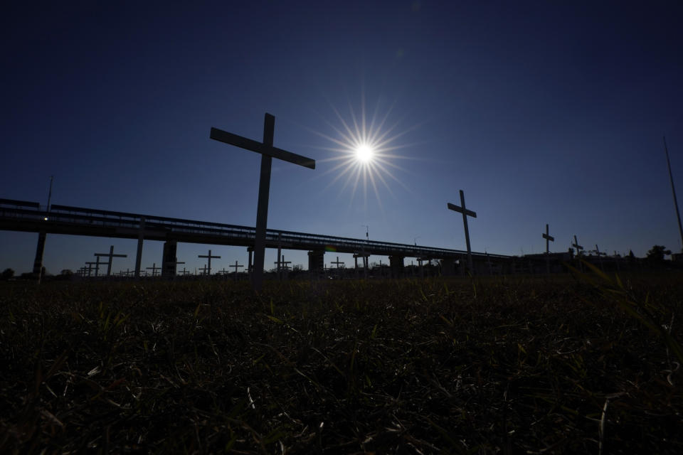 Crosses places in memorial for migrants that died trying to cross the Rio Grand into the U.S. from Mexico stand near an international bridge, Wednesday, Jan. 3, 2024, in Eagle Pass, Texas. According to U.S. officials, a Mexican enforcement surge has contributed to a sharp drop in illegal entries to the U.S. in recent weeks.