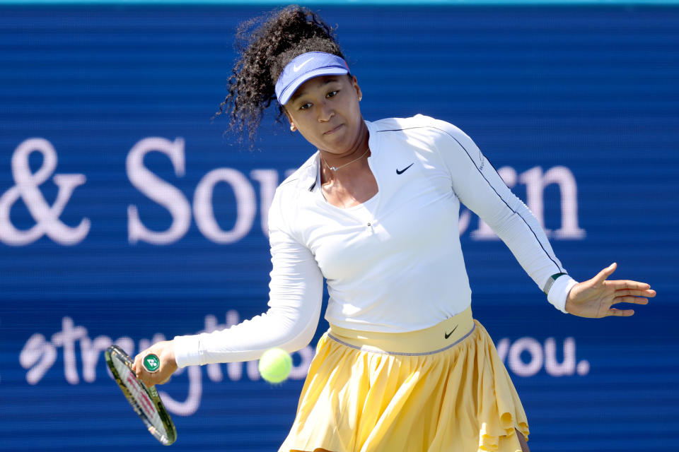 Seen here, Naomi Osaka returns a shot against Shuai Zhang during their first round clash in Cincinnati.