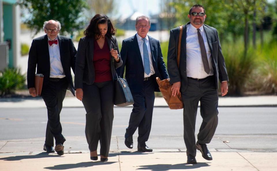 Kenneth Ritchey, center right, walks into the United States District Courthouse alongside his attorneys in Gulfport on Monday, Sept. 27, 2021.