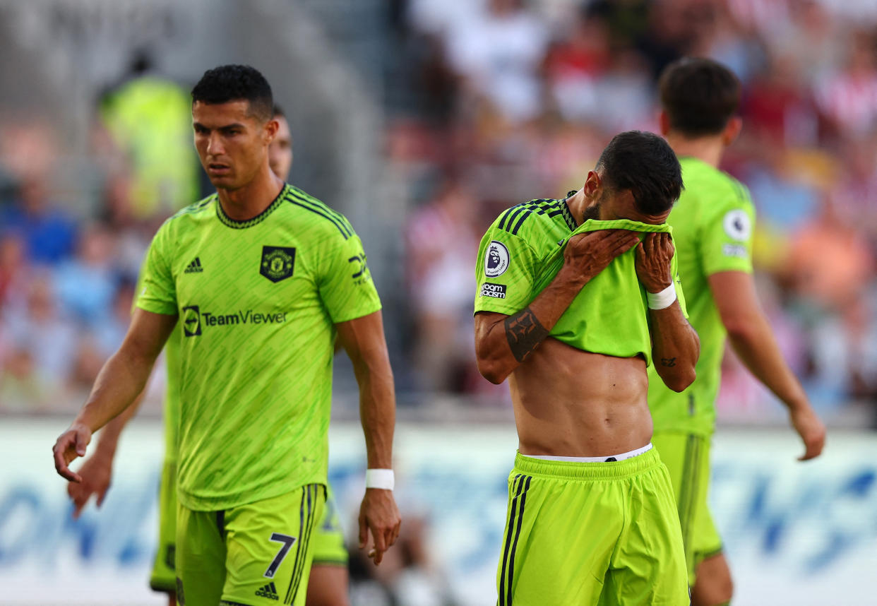 Manchester United's Cristiano Ronaldo (left) and Bruno Fernandes bow their heads in disappointment after their 0-4 defeat by Brentford in the English Premier League. 