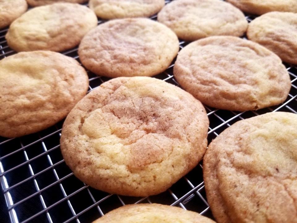 Pumpkin spice snickerdoodle cookies on a cooling rack right out of the oven.