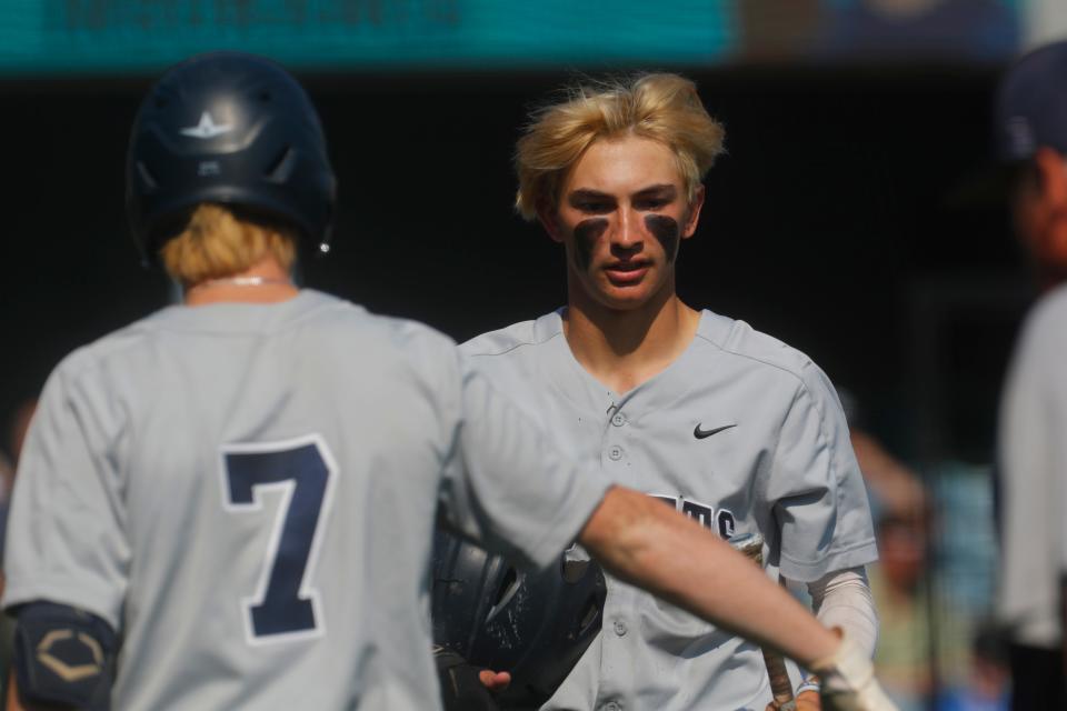 Shelby County’s Carter White celebrates scoring against Eastern in the Clark's Pump-N-Shop Baseball State Tournament with teammate Myles Strong on June 3, 2023.