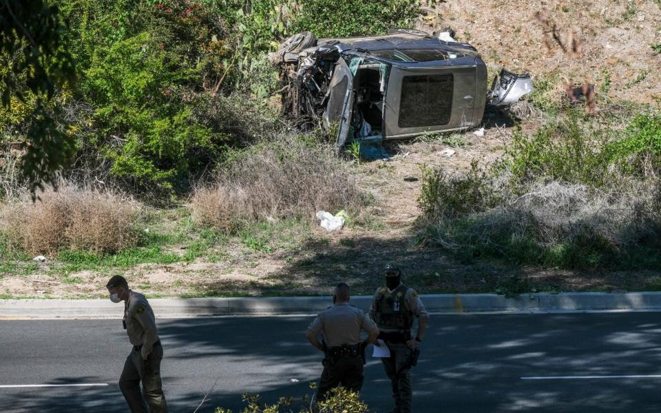 A vehicle rests on its side after a rollover accident involving golfer Tiger Woods along a road in the Rancho Palos Verdes section of Los Angeles - AP